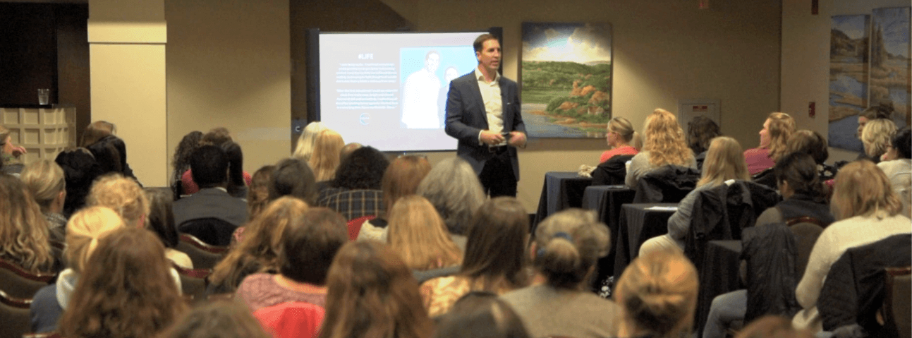 Dr. Steve Tullius presenting to a packed room